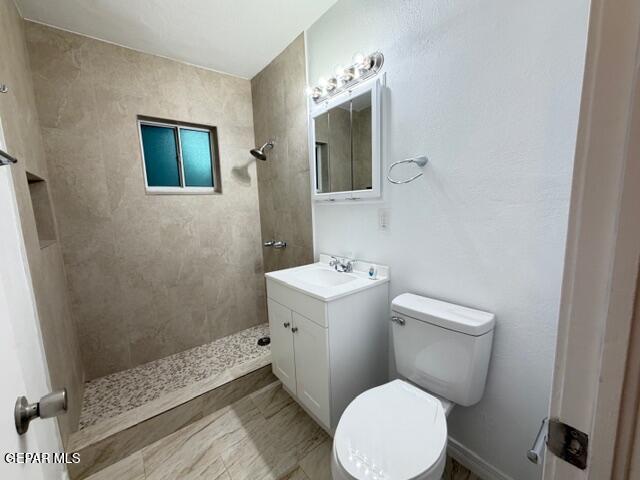 305 Edith Drive El Paso, TX 79915 - Photo 16 of 25 a white toilet sitting next to a bathroom sink