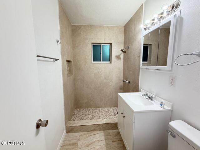 305 Edith Drive El Paso, TX 79915 - Photo 17 of 25 a bathroom with a sink a toilet and shower