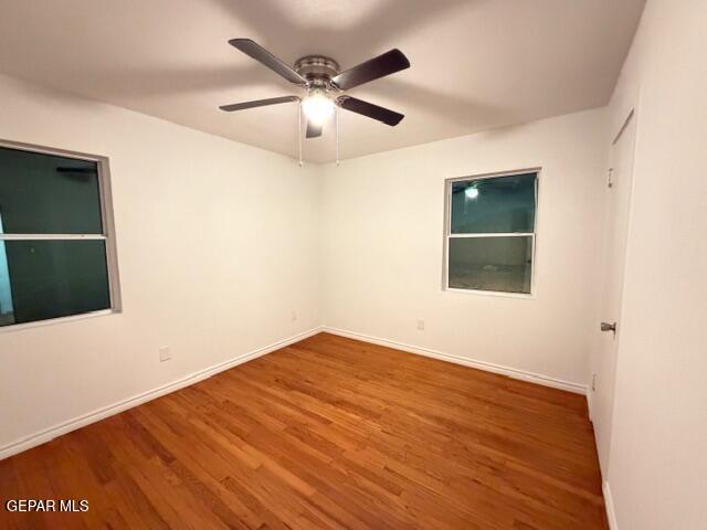 305 Edith Drive El Paso, TX 79915 - Photo 19 of 25 an empty room with wooden floor and windows