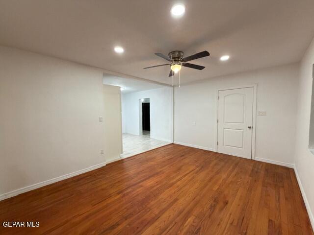 305 Edith Drive El Paso, TX 79915 - Photo 7 of 25 a view of an empty room with a chandelier fan and wooden floor