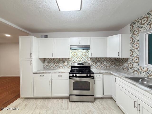 305 Edith Drive El Paso, TX 79915 - Photo 9 of 25 a kitchen with white cabinets and appliances