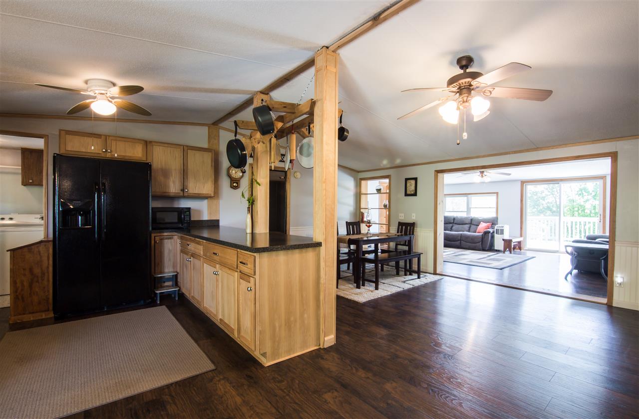 9478 Waggys Creek Road Dayton, VA 22821 - Photo 23 of 36 a view of a livingroom with furniture ceiling fan and wooden floor