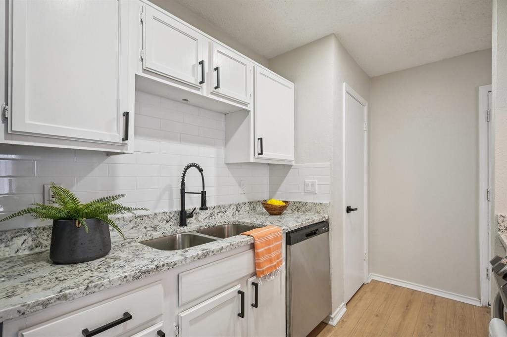 18333 Roehampton Drive, Unit 128 Dallas, TX 75252 - Photo 24 of 40 a kitchen with stainless steel appliances granite countertop a sink a stove and cabinets