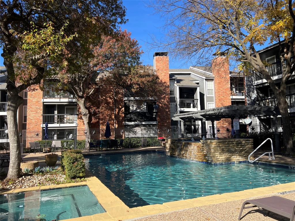 18333 Roehampton Drive, Unit 128 Dallas, TX 75252 - Photo 39 of 40 a view of house with swimming pool and a yard