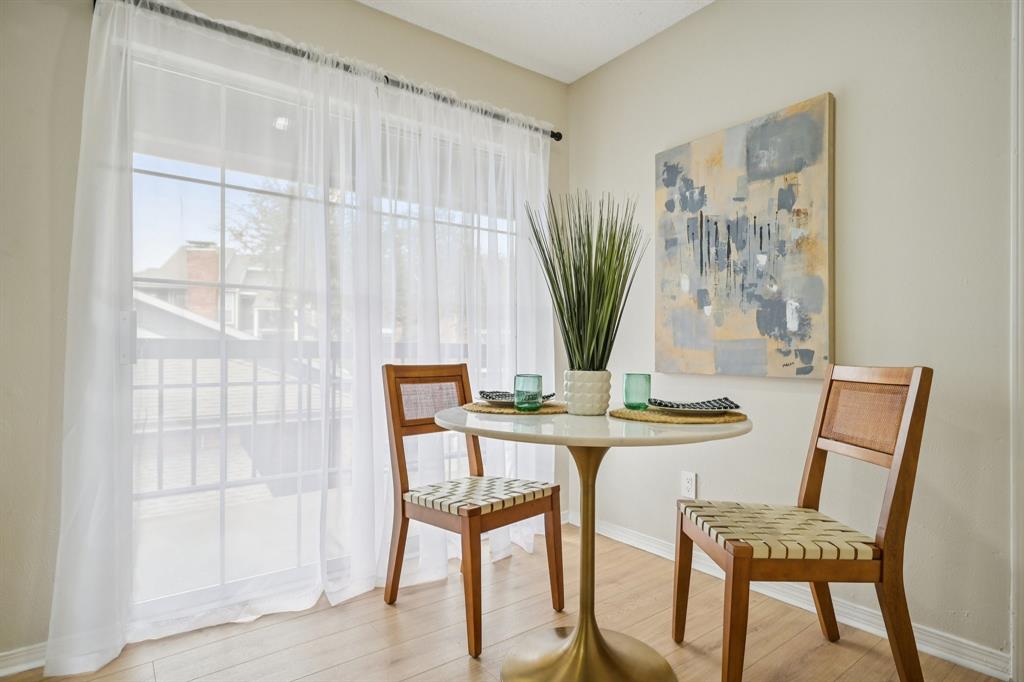 18333 Roehampton Drive, Unit 128 Dallas, TX 75252 - Photo 5 of 40 a view of a dining room with furniture and a potted plant