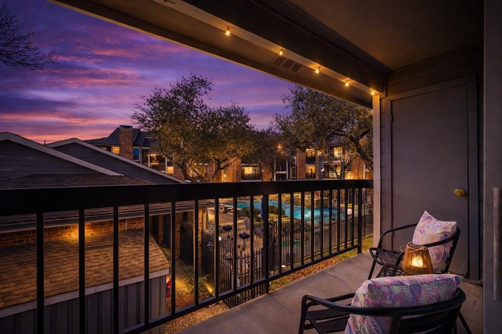 18333 Roehampton Drive, Unit 128 Dallas, TX 75252 - Photo 6 of 40 a view of a balcony with chair and wooden floor