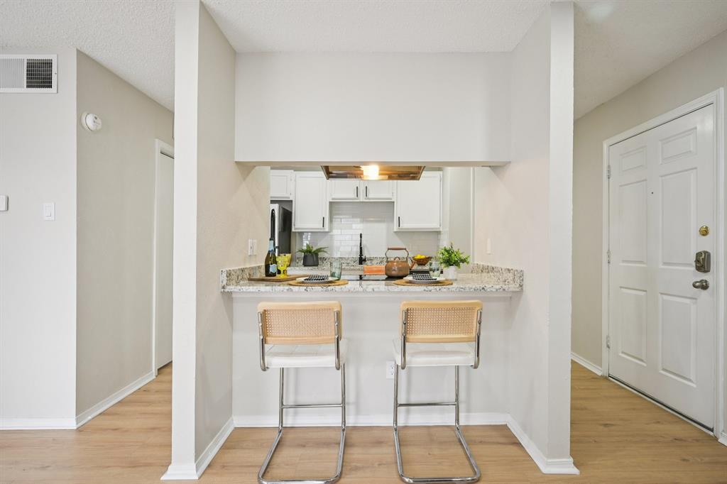 18333 Roehampton Drive, Unit 128 Dallas, TX 75252 - Photo 8 of 40 a kitchen with stainless steel appliances a sink and cabinets