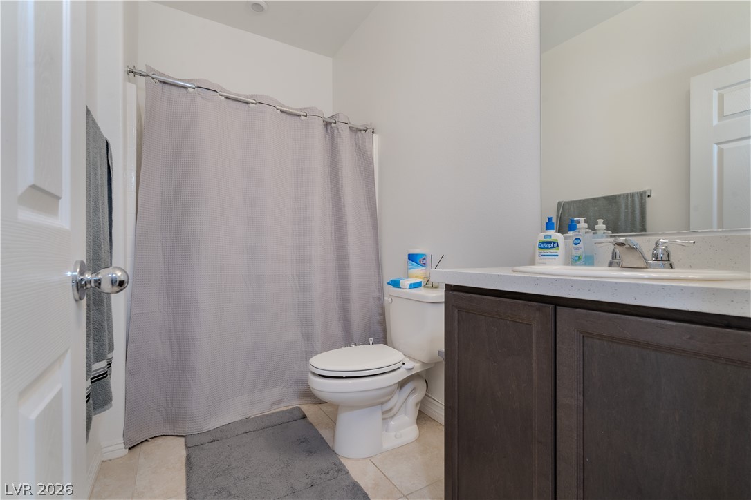 1239 Raritan Place Henderson, NV 89002 - Photo 18 of 26 Bathroom with vanity, curtained shower, and light tile patterned floors