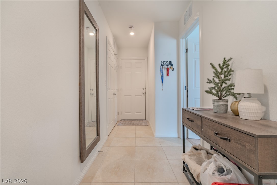 1239 Raritan Place Henderson, NV 89002 - Photo 7 of 26 Hallway with light tile patterned floors and baseboards