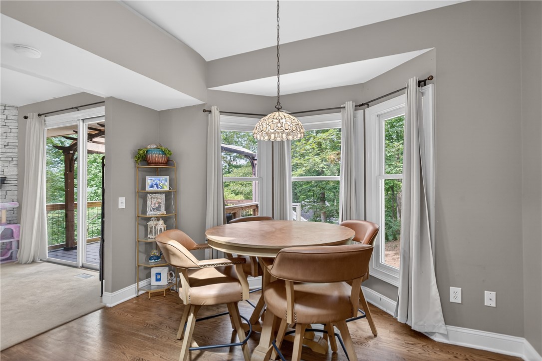 136 Loran Pointe Circle Seneca, SC 29672 - Photo 12 of 50 A well-lit dining area offers hardwood floors and picturesque views of the surrounding natural landscape.