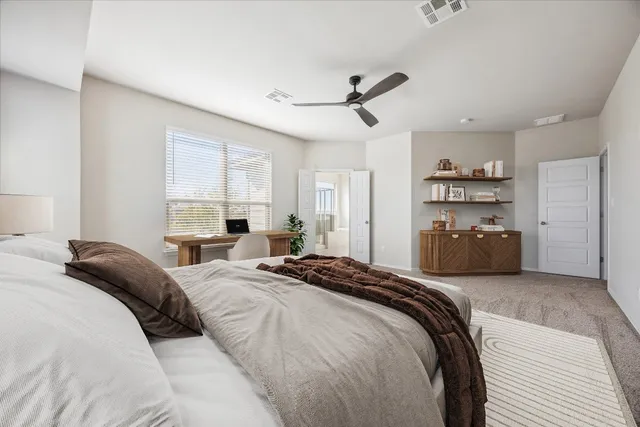 a bedroom with a bed and a window