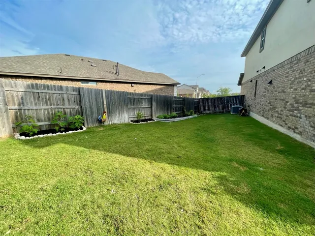 a view of a backyard with plants and garden