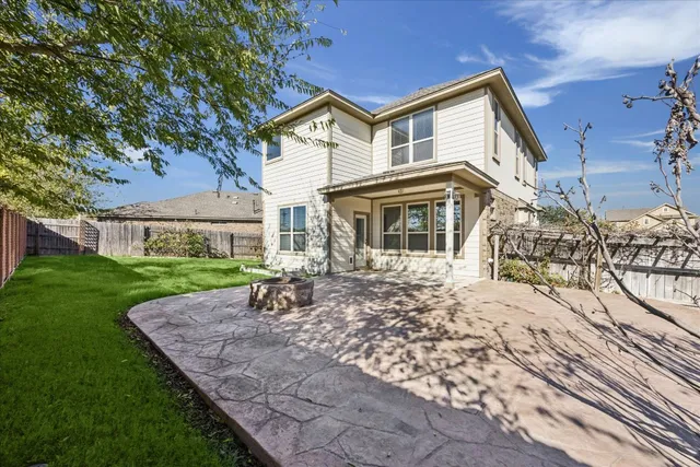 a view of a patio with table and chairs under an umbrella