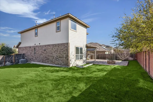 a living room with a fireplace and a rug