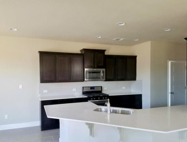 1036 Chad Loop Round Rock, TX 78665 - Photo 3 of 22 a kitchen with granite countertop a stove and a refrigerator
