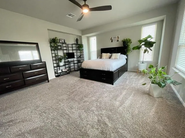 a spacious bedroom with a bed and a bookshelf