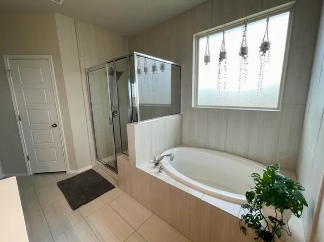 a bathroom with a bathtub and a shower