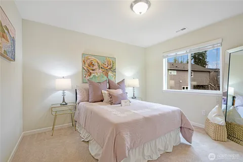 a bedroom with a bed and a large window