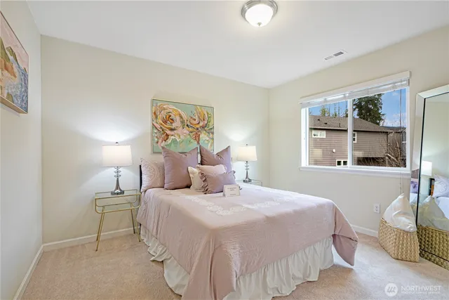 a bedroom with a bed and a large window