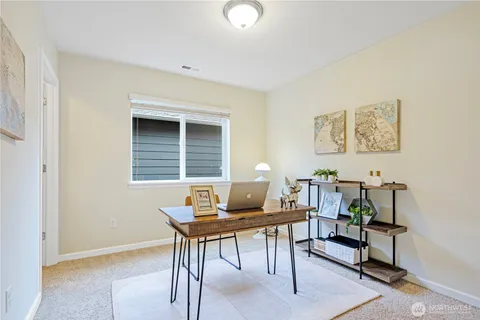 a workspace with furniture and a window