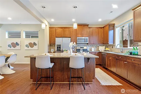 a kitchen with a table chairs stove and microwave