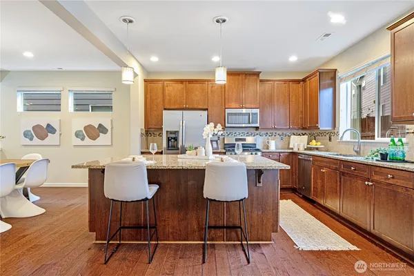 a kitchen with a table chairs stove and microwave