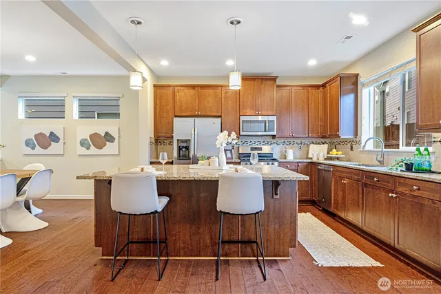 a kitchen with a table chairs stove and microwave