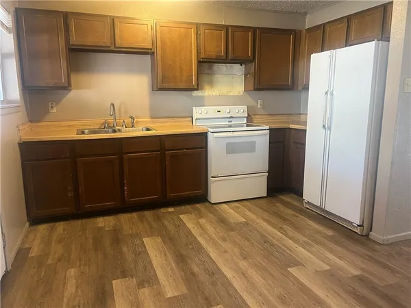 a kitchen with a sink cabinets and appliances