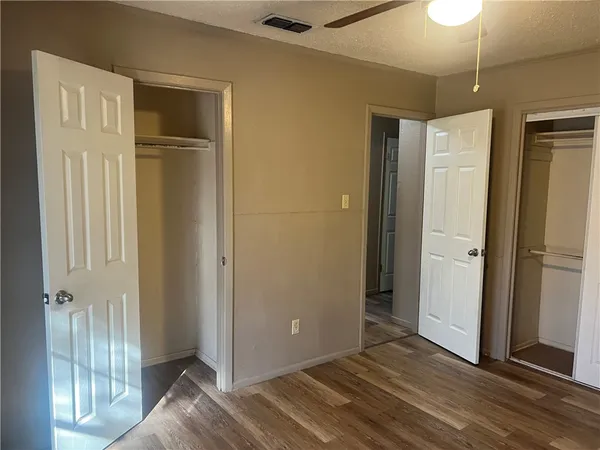 a view of a livingroom with wooden floor and window