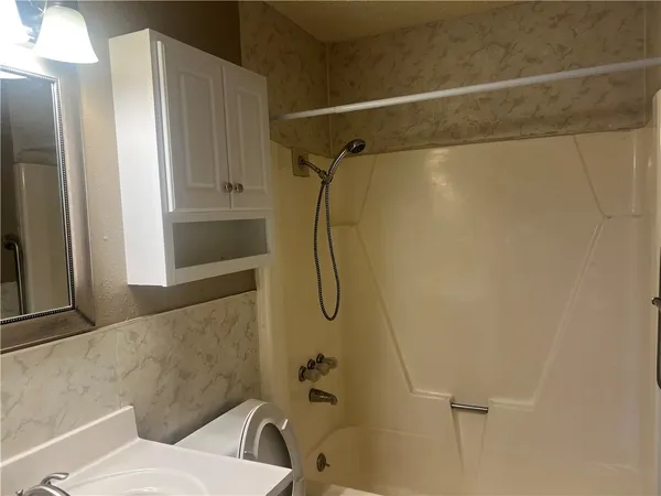 a bathroom with a shower and a shower