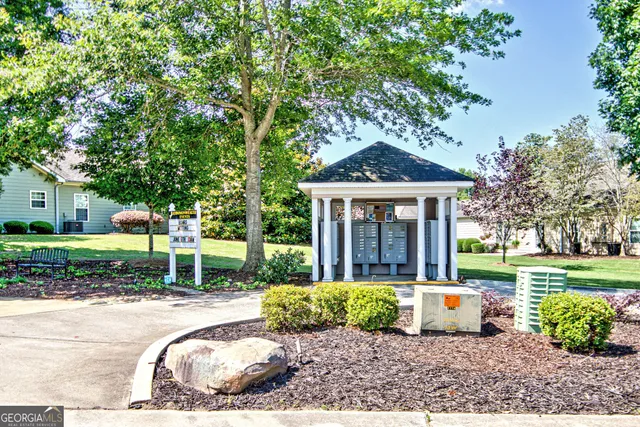 a view of a house with backyard and sitting area