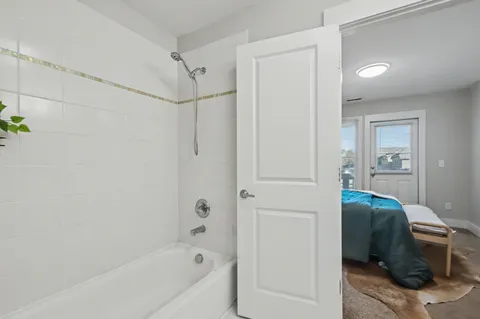 a en suite bathroom with a granite countertop tub and a shower