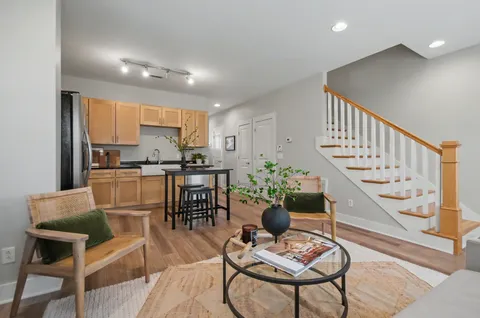 a dining room with furniture and wooden floor