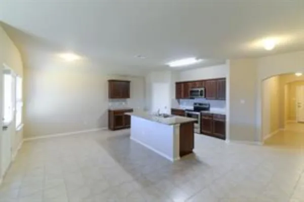 a large kitchen with a sink and stainless steel appliances
