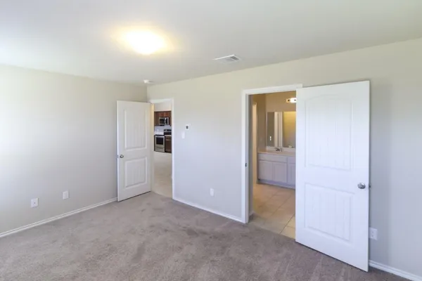 an empty room with closet and a bathroom