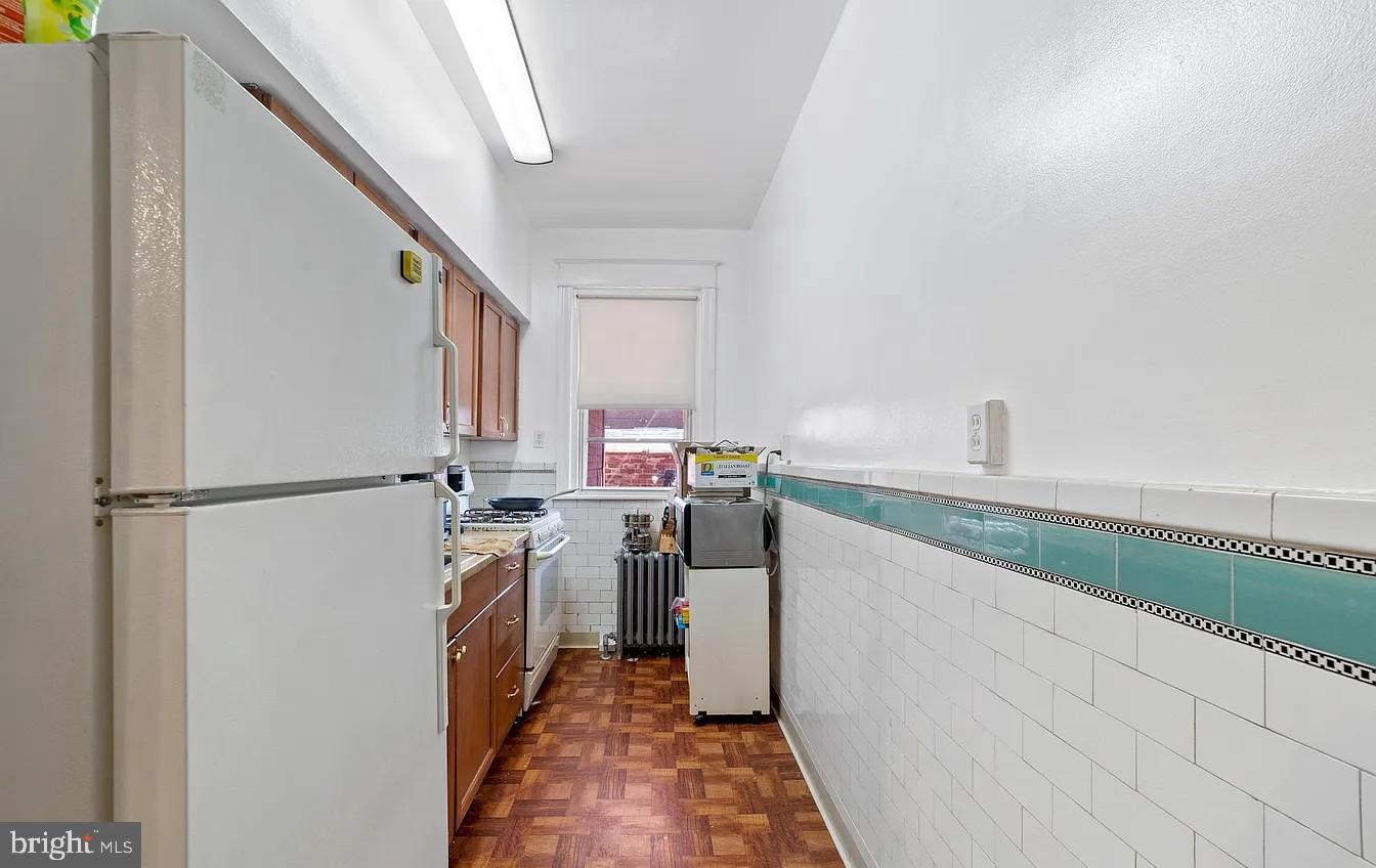 2329 Rhawn Street Philadelphia, PA 19152 - Photo 11 of 23 a kitchen with a refrigerator and a sink