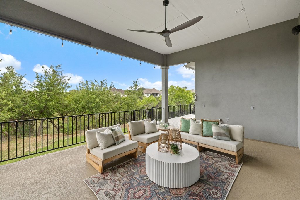 17641 Stratus Cove Dripping Springs, TX 78620 - Photo 32 of 40 a living room with furniture and a floor to ceiling window