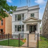 a front view of a house with a iron gate