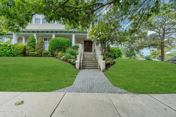 a front view of house with yard and green space