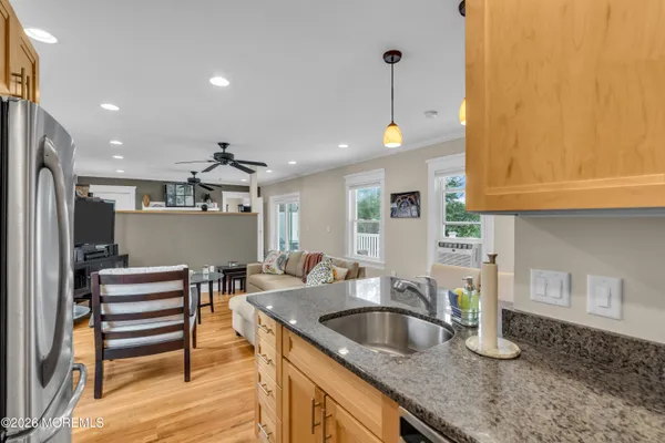 a kitchen with stainless steel appliances granite countertop a sink a stove and a refrigerator