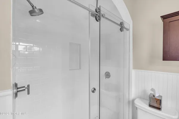 a bathroom with a shower and a sink