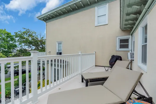 a view of a chairs and table in the balcony