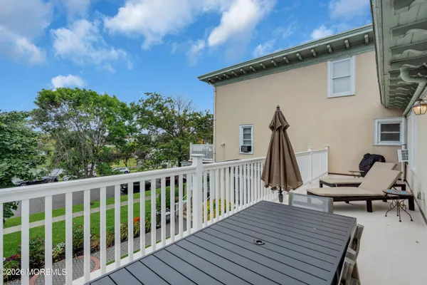 a view of a deck with wooden floor and outdoor seating