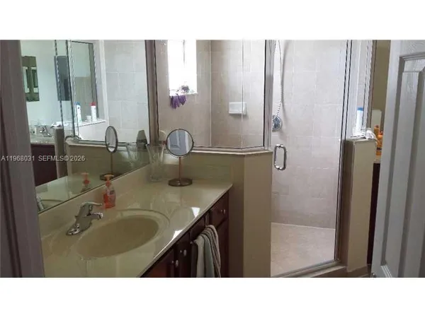 a bathroom with a sink double vanity and a mirror