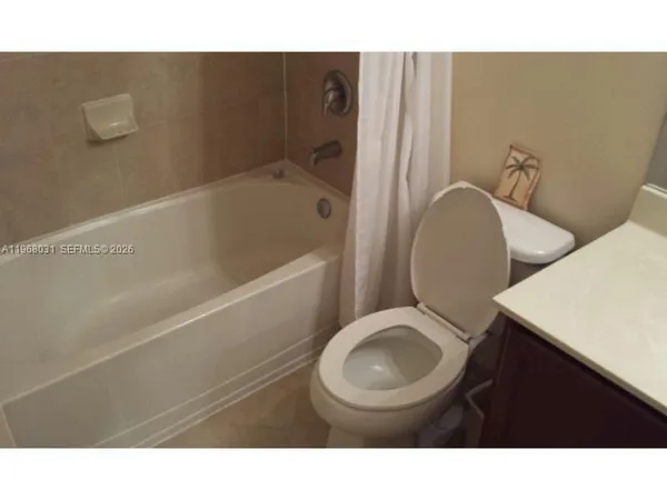 a bathroom with a toilet a sink and bathtub