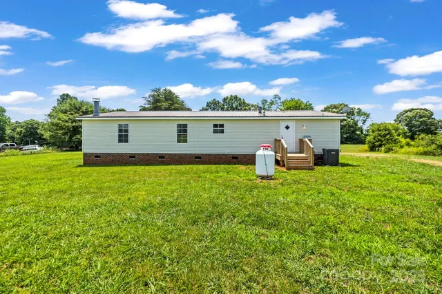 a view of a house with a backyard porch and furniture