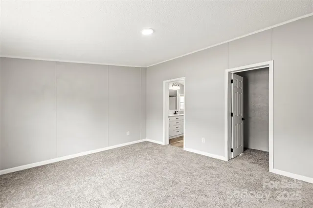 an empty room with closet and bathroom