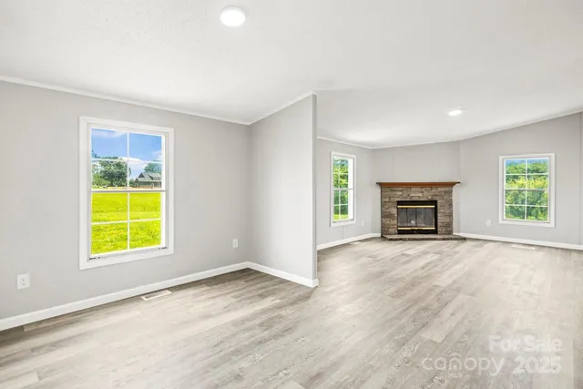 an empty room with a window and a fireplace
