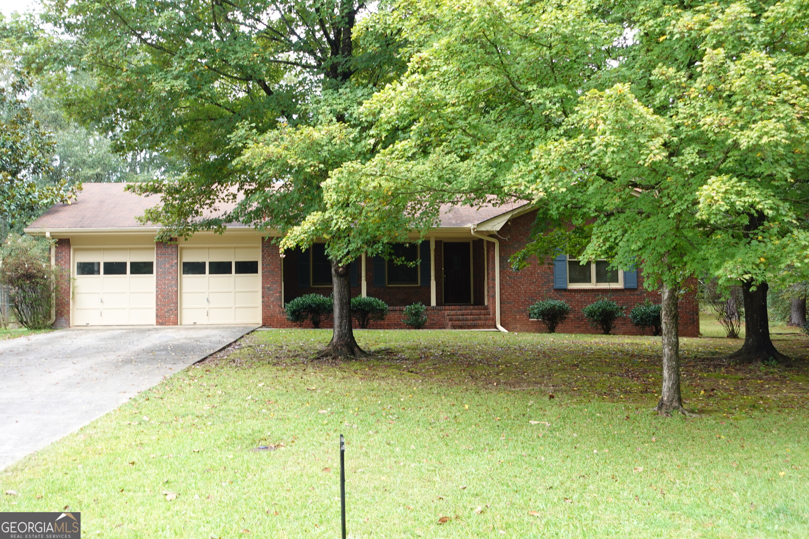 263 Elks Street Winder, GA 30680 - Photo 1 of 1 a front view of a house with a garden and trees