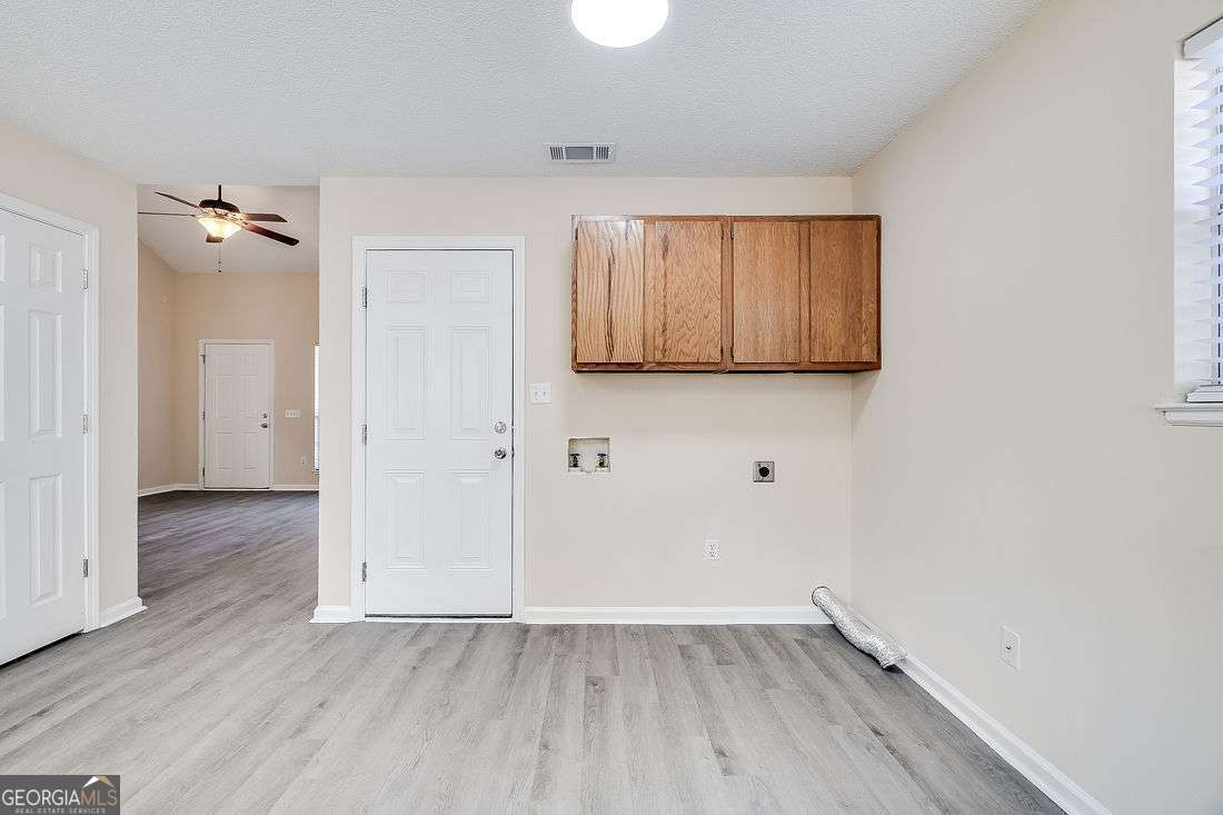 145 John Glenn Drive Rincon, GA 31326 - Photo 13 of 29 an empty room with wooden floor and windows